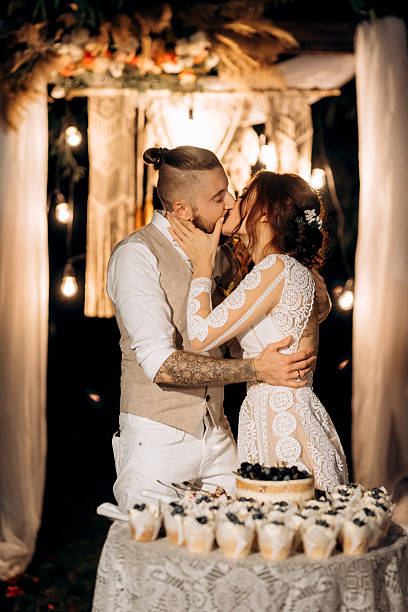 istock newlyweds happily cut and taste the wedding cake 2231810444