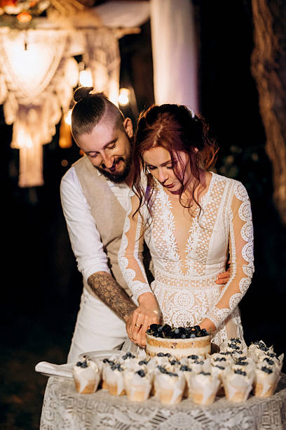 istock newlyweds happily cut and taste the wedding cake 2231810868