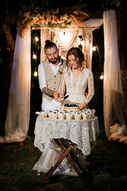 istock newlyweds happily cut and taste the wedding cake 2231810918