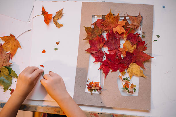 istock Creating a fall-inspired art project using colorful leaves and paper indoors 2231816845