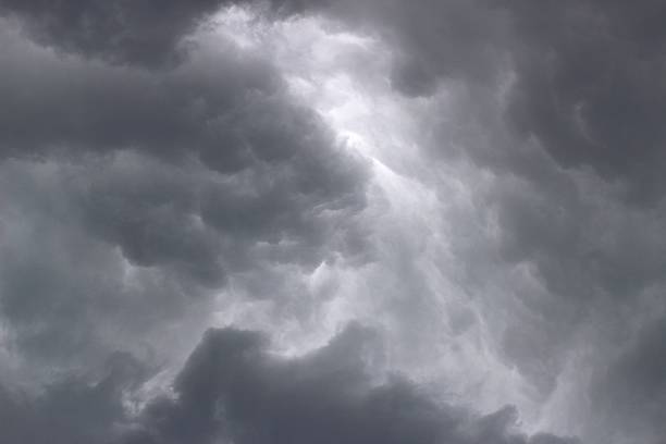 istock Dark storm clouds gather over a quiet landscape 2231819807