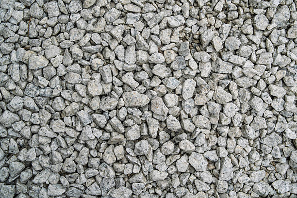 Close-up of small gray gravel stones forming a rough surface, natural pattern useful for backgrounds, construction, and design elements.