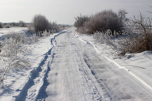 A snow-blanketed trail meanders through a serene winter landscape.
