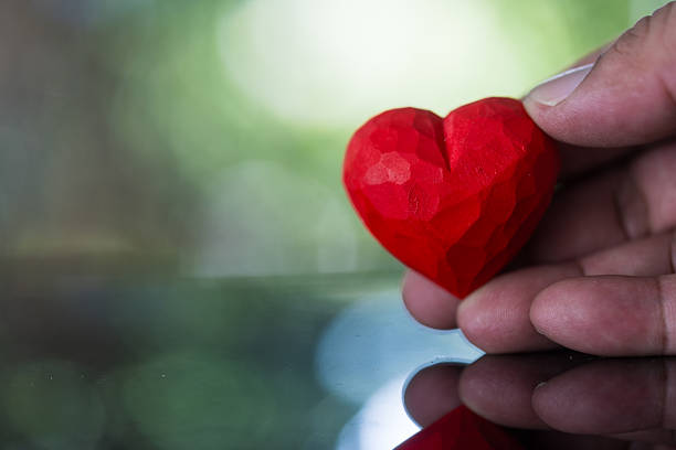 istock The man is holding a red heart. 2231823983