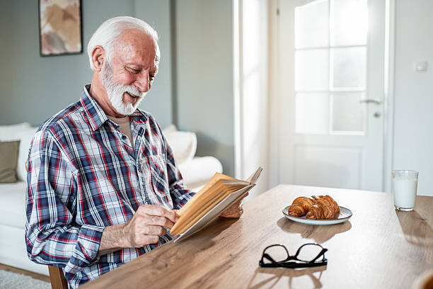 Cappuccino aroma cup of coffee for breakfast in cafe on wooden table background with newspaper. Morning sunlight coming from window on sun day or holiday. Leisure business idea. Copy space room text