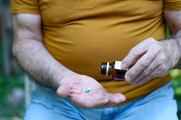 istock A senior Iranian man eats pills at home 2231834410