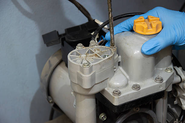 istock A technician is repairing an old, broken automatic water pump. 2231834894