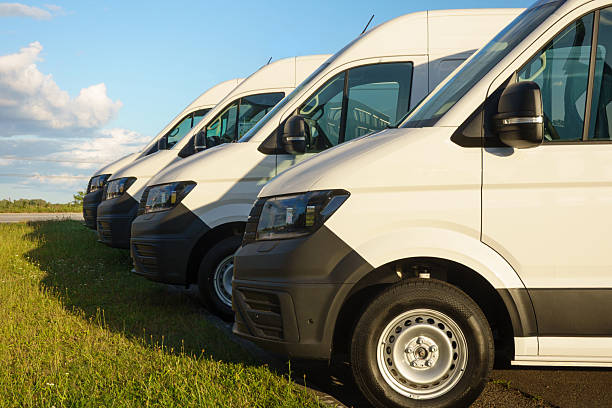 istock White Delivery Vans Parked In Row 2231835584