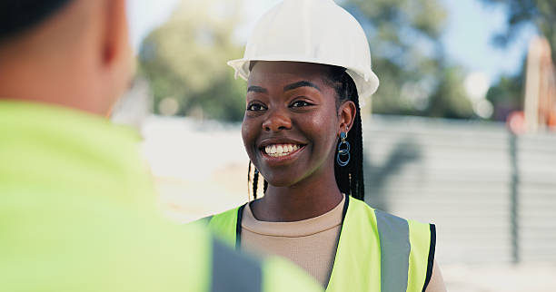 istock Woman, engineer and discussion at construction site with smile for, update and property development. Person, architect and technician with talk, happy or feedback for real estate expansion 2231836020