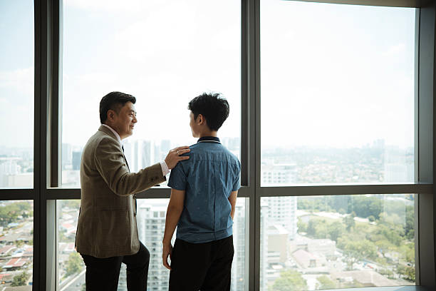 istock Father Sharing Wisdom With Son at City Viewpoint 2231837700