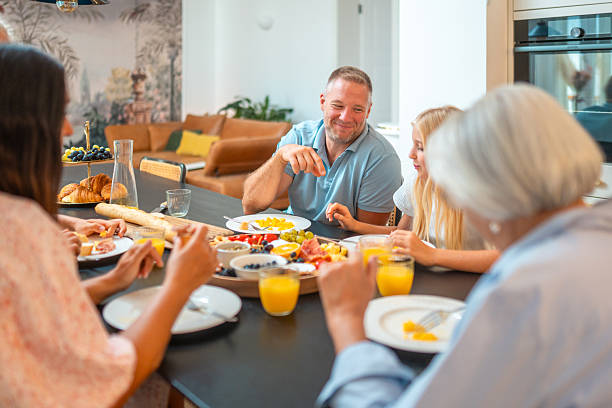 istock Family Sharing Breakfast Around a Table at Home 2231838176
