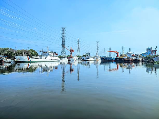 Jakarta, Indonesia - August 17, 2025 : A Tanjung Priok harbor and ships docked at the pier as well as electric poles that decorate the pier