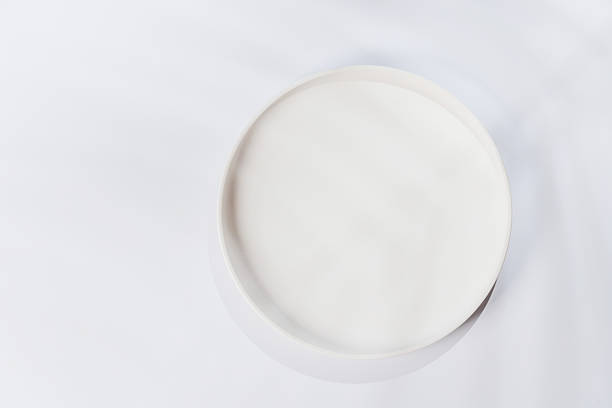 istock Empty plate on a white background with leaf shadows, perfect food mockup 2231846117