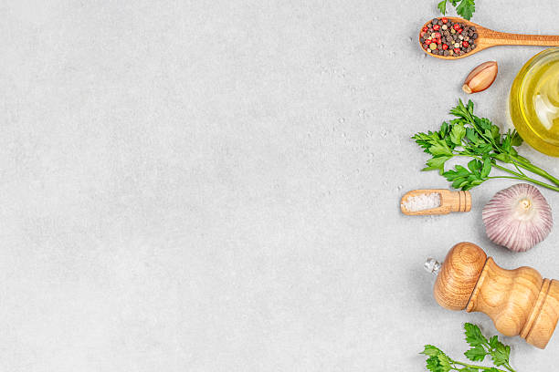 istock Assorted cooking ingredients with herbs, garlic, and spices on light background, top view. copy space 2231846337