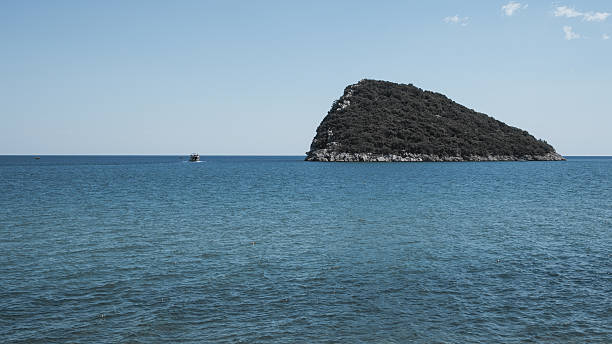 A small island opposite and deep blue sea and sky