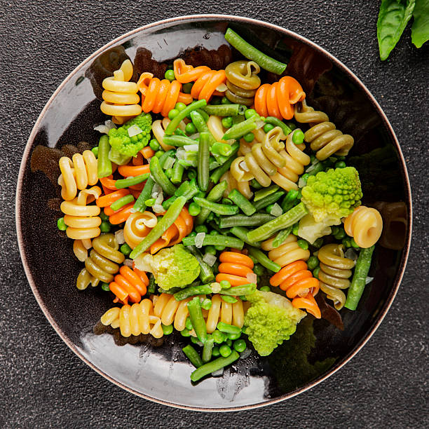 istock Trottole pasta vegetables green peas, green beans, kohlrabi cabbage, broccoli second course tasty snack fresh delicious gourmet food background on the table rustic food top view copy space 2231847182