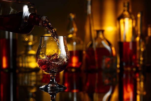 istock Pouring brandy from a bottle into a glass. 2231851143