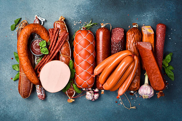 istock Different types of tasty sausages on grey table, flat lay 2231853126