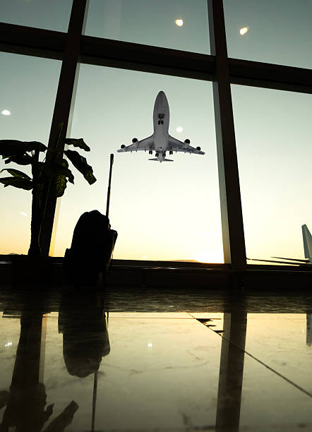 istock Plane Landing Viewed Through Airport Windows 2231853523