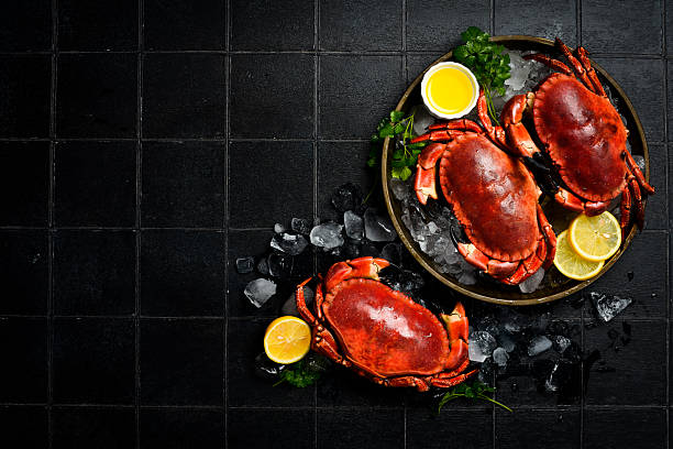 istock Crab. Three boiled red crabs on a plate, ready to eat. Close-up. 2231854701