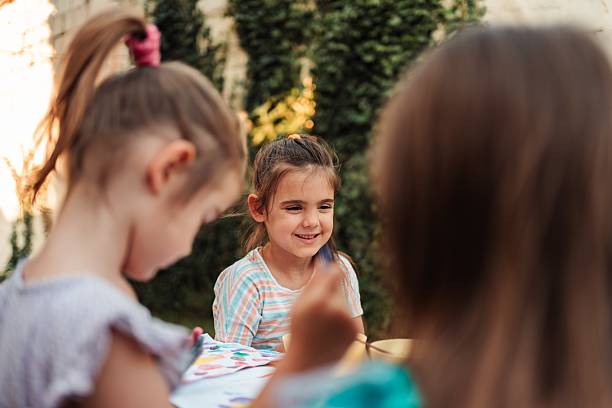 istock Children painting outdoors having fun together during a sunny day 2231857327