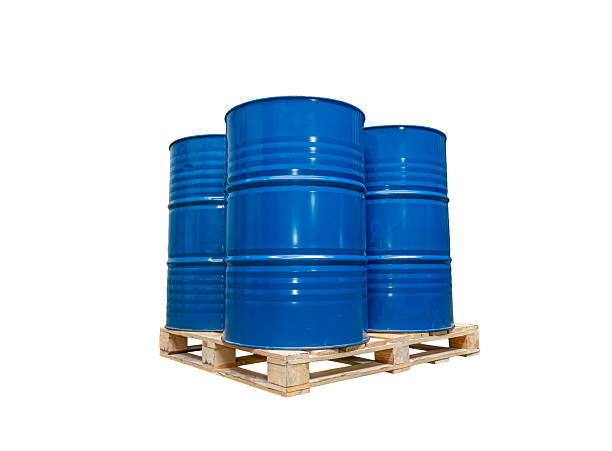 Group of blue metal barrels placed on a wooden pallet, used for industrial liquid storage, oil, chemicals, and hazardous material transport.