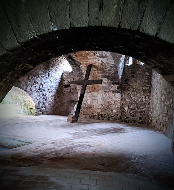 Wooden Cross Inside Old Stone Chapel with Arched Ceiling