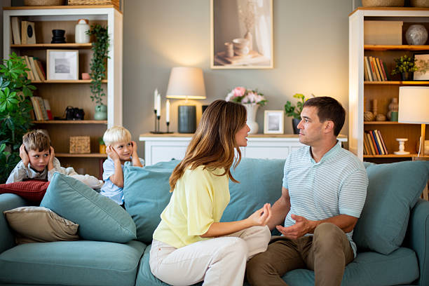 istock Parents arguing while children covering ears on sofa at home 2231861836