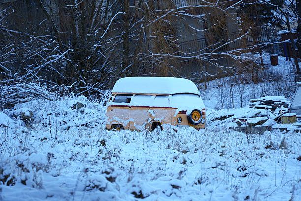 Snow covered old beige van.