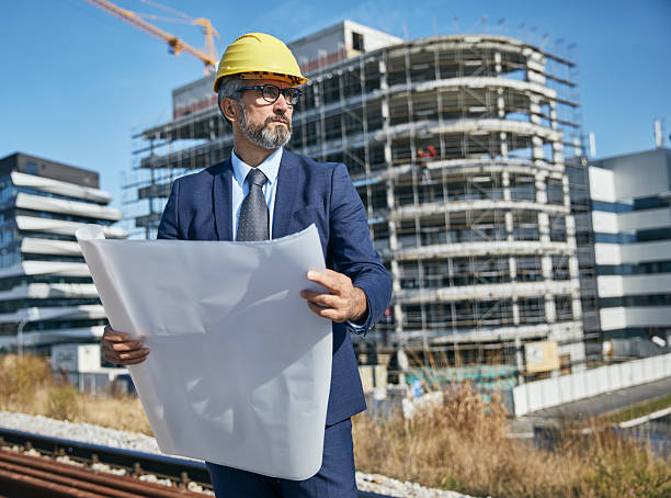 istock senior businessman architect helmet construction site building architecture tablet computer protective workwear blueprint plan 2231863947