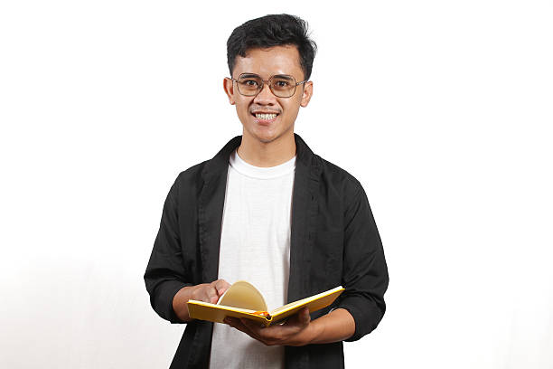 istock Asian man wearing black shirt over white t-shirt reading diary 2231868930