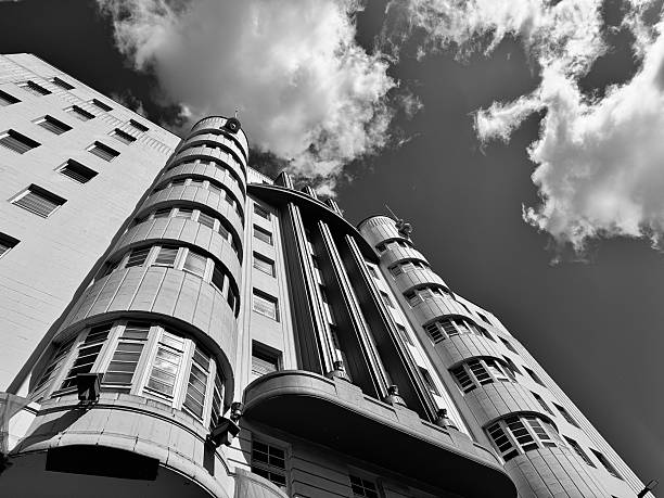 Looking up at a tall art deco building against cloudscape in Glasgow