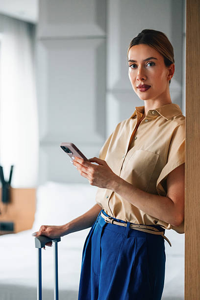istock Confident Professional Woman in Modern Interior Holding Smartphone 2231869270