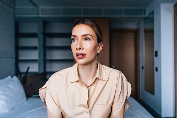 Thoughtful Woman Sitting in a Modern Room With Minimalistic Design