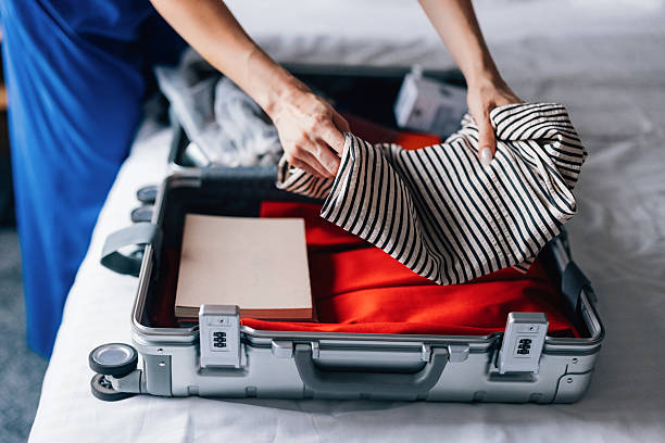 istock Person Organizing Clothes Into a Suitcase for Travel 2231869304