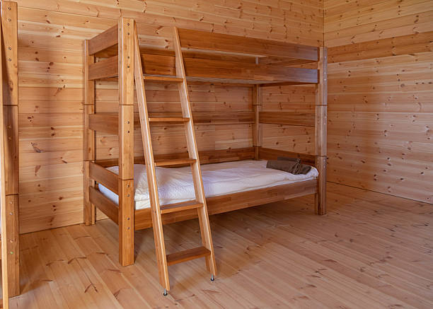 Minimalist bedroom features. Cozy wooden bunk beds in a camping, vocation sleepover.
