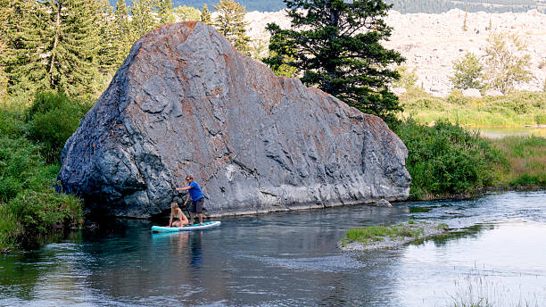istock Adult siblings SUP board on mountain river 2231879677