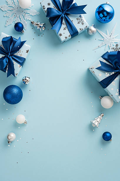 istock Holiday-themed vertical composition featuring wrapped presents, ornaments, and festive decorations in a blue palette 2231879815