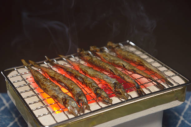 istock Grilling Shishamo roe on a charcoal grill with smoke rising 2231880175