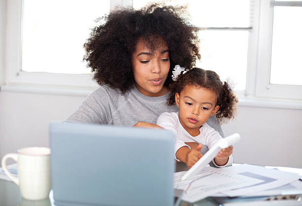 istock Young mother working and spending time with her daughter 2231883819
