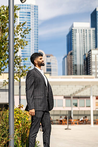 istock Man Looking Up at Sky in Sophisticated City 2231884956