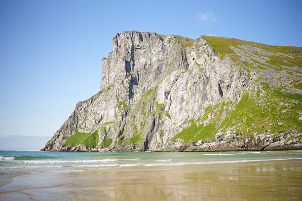 View across beach, sea and mountains in fjord, Kvalvika Beach, Lofoten Islands