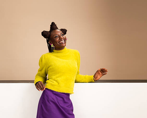 istock Smiling African woman leaning back in vibrant studio portrait 2231887577