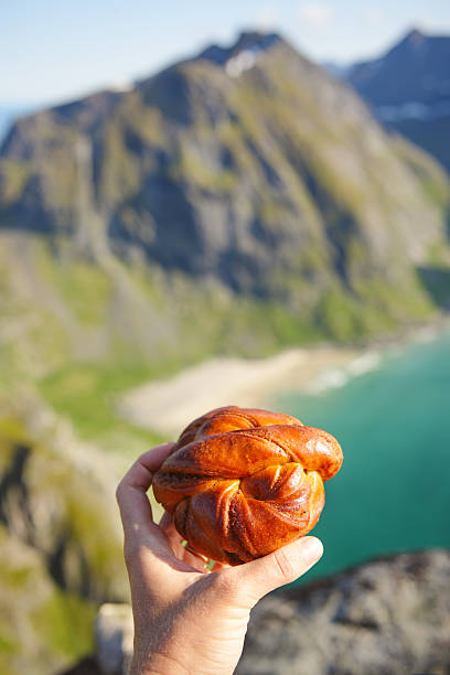 istock Hand holding pastry on viewpoint above beach and sea 2231887695