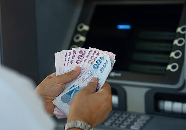 istock Man holding Turkish Lira Bill Cash at Atm machine 2231890926