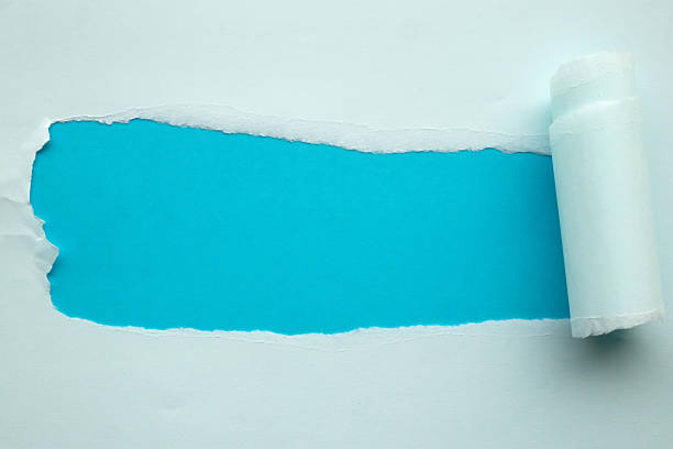 istock Blue torn paper rolled edge with space on blue background 2231895923