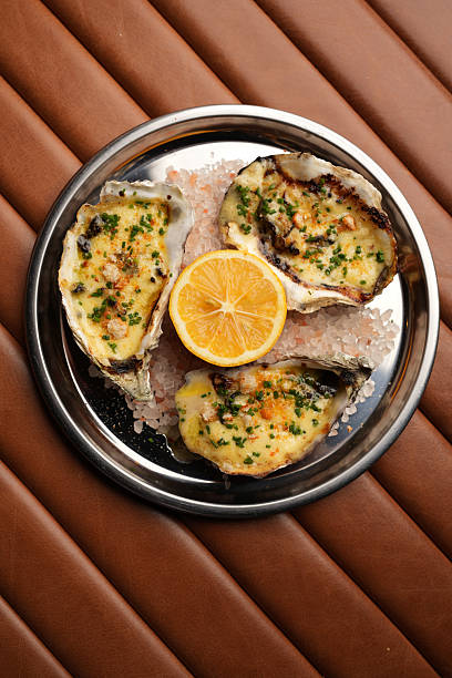 Baked Oysters with Lemon, Served on a Metal Plate
