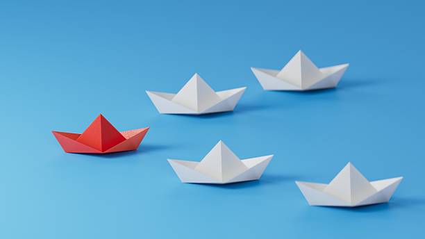 istock Different business concept.new ideas. paper art style. creative idea.Leadership concept, red paper ship leading among white.3D rendering on blue background. 2231900936