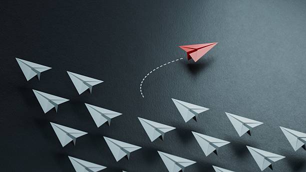 istock Red paper plane floating between others on light black background, flat lay. Uniqueness concept.new ideas. paper art style. creative idea.3D rendering on black background. 2231900953
