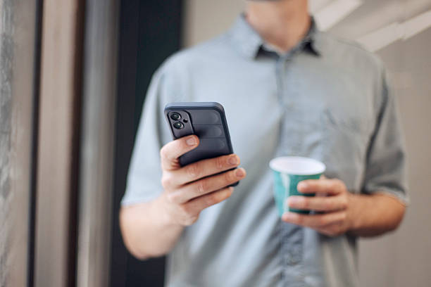 istock Businessman Holding Smartphone and Coffee 2231901454